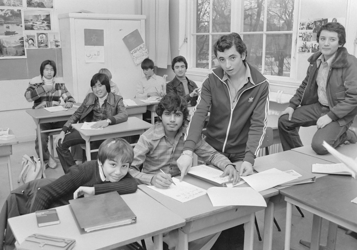 a group of kids sitting at desks in a classroom
